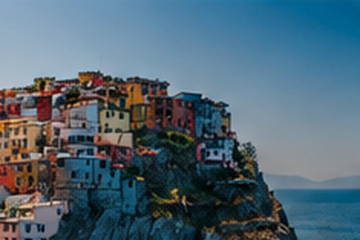 A colorful coastal town built along a rocky shoreline.